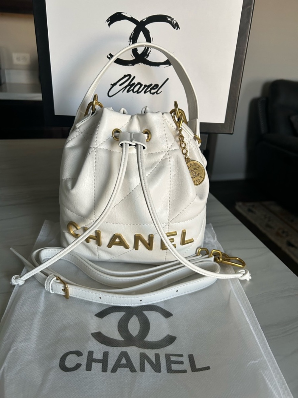 CHANEL VIP GWP White Quilted Mini Drawstring Bucket Bag with Gold Hardware.